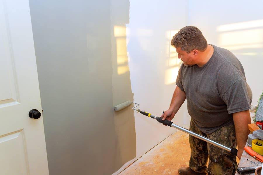 man-painting-interior-room